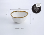 Pampa Bay porcelain serving bowl a white ceramic dish featuring a decorative beaded gold rim shown with its dimensions 5x5.5x2.75 inches and a black circular It's Porcelain product label
