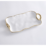 White ceramic serving tray with an organic wavy gold trim and two attached gold ring handles