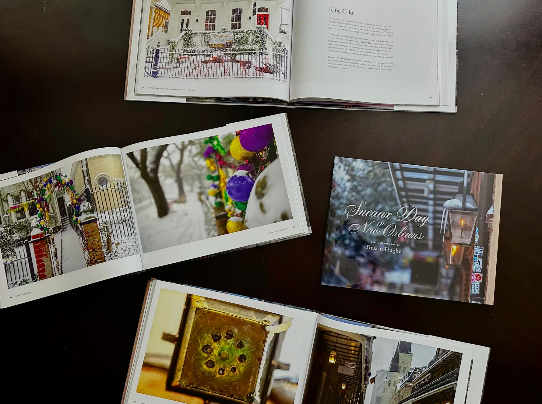 Dustin Hughes photography books depict a rare Sneaux Day in New Orleans, featuring snow-dusted historic architecture including St Louis Cathedral, vibrant purple gold and green Mardi Gras beads, and details on King Cake