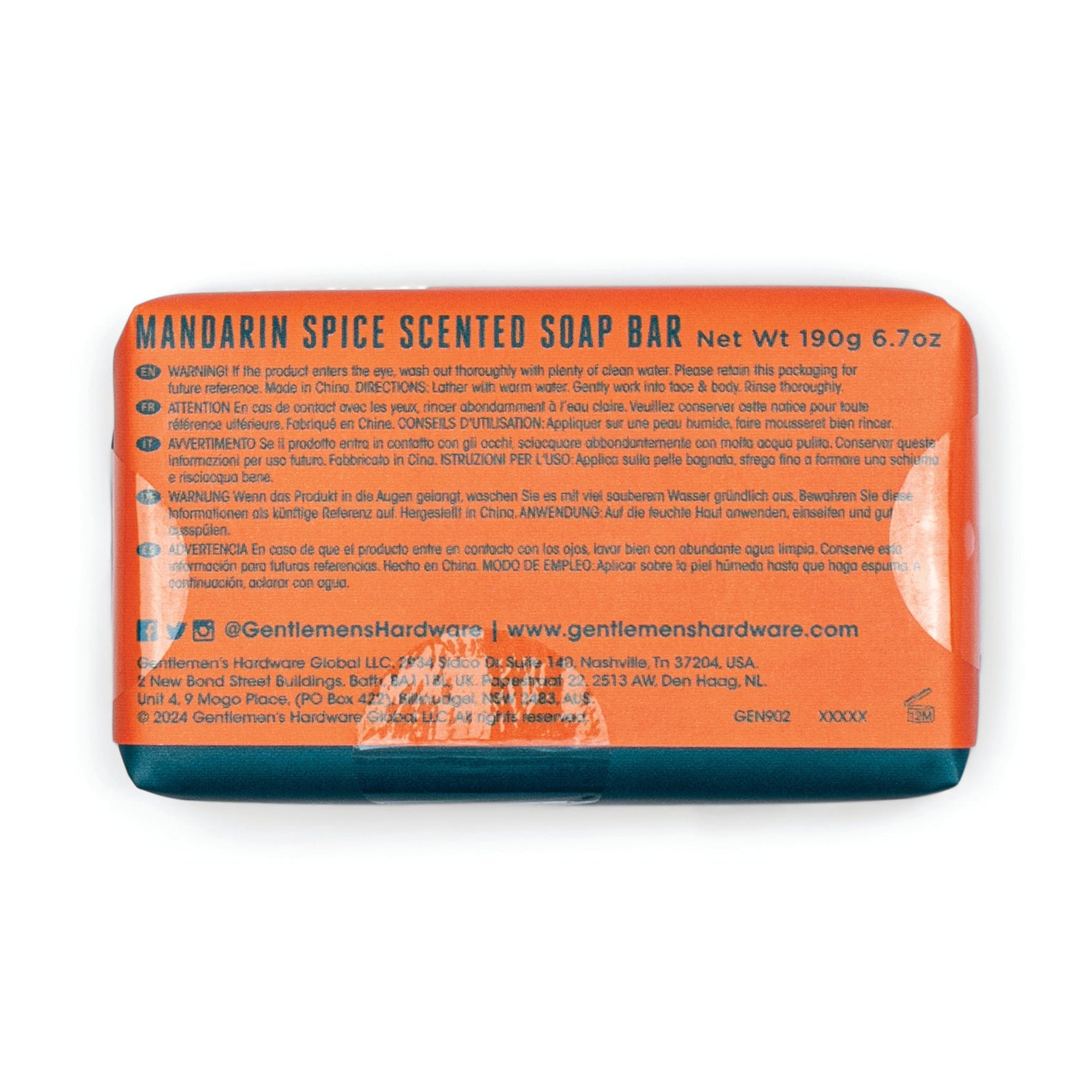 Photograph of a Gentlemen's Hardware Mandarin Spice Scented Soap Bar in vibrant orange packaging with a dark teal bottom, displaying "Net Wt 190g 6.7oz" and multilingual warnings