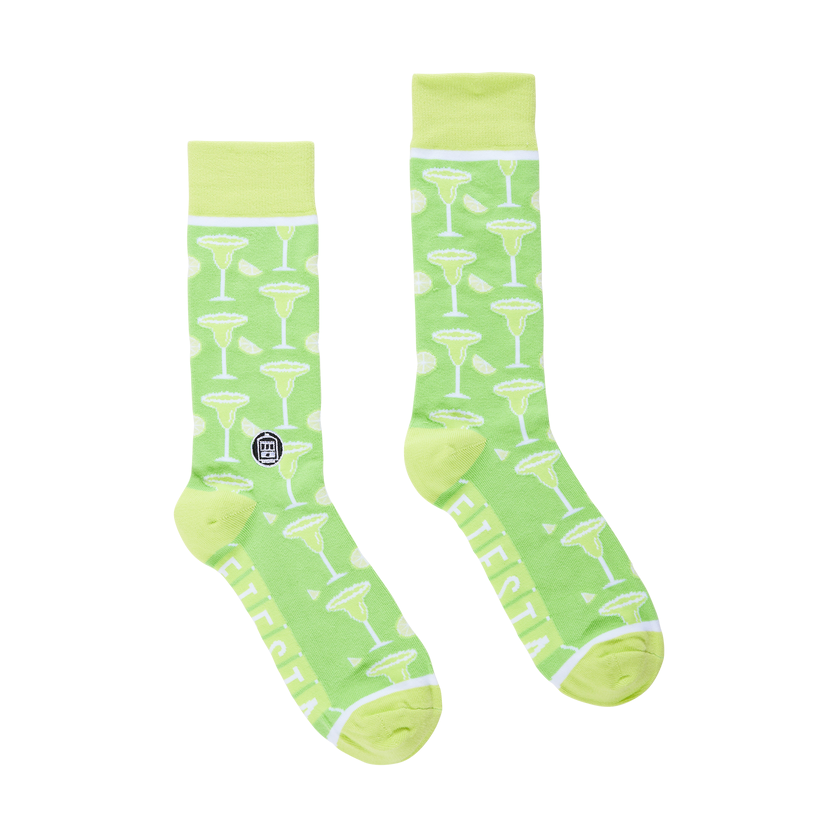 Green socks with martini glass pattern on a white background