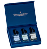 Mistral men's fragrance gift set in a luxurious dark blue presentation box, featuring gold foil text on its inner lid and three clear glass bottles with black caps for Surf Hossegor, Golf Valbonne, and Ride Ventoux Eau de Parfum