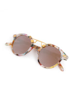 Product photography of round sunglasses featuring a pastel multi-color iridescent frame brown lenses and a unique gold double bridge on a white background