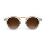 Translucent pale blue panto-style sunglasses with brown gradient lenses and gold-toned metal double bridge and rivet details