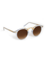 A pair of stylish sunglasses with light blue translucent round frames, brown gradient lenses, and gold metal accents including a double bridge and textured temple arms on a white background