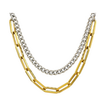 Layered necklace featuring a shiny silver-colored curb chain above a bolder gold-colored paperclip chain