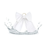 White fabric bow with a gold ring attachment surrounded by a water splash