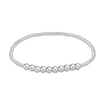 A silver stretch bracelet composed of tiny uniform spherical beads interspersed with a central row of nine larger polished silver beads against a clean white background