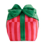 Plush gift box with bold red and pink vertical stripes and a vibrant green velvet bow