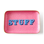 Rectangular pink decorative tray with a subtle polka dot pattern and a gold rim, featuring the bold retro-style word STUFF in blue lettering