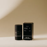 Product photograph of a black cylindrical Preston SPF 50 Zinc Oxide Sunscreen Face Stick next to its matching rectangular box, both displaying white text on a warm neutral background with subtle shadows