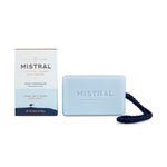 Product photo of a light blue Mistral Surf Hossegor Soap on a Rope with a dark blue braided cord, next to its white and dark blue packaging featuring a surfer icon