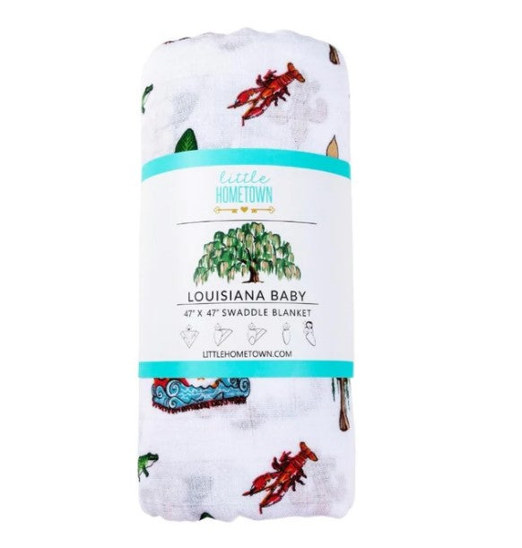 Rolled white swaddle blanket with Louisiana themed illustrations including crawfish and cypress trees