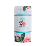 Rolled white swaddle blanket with pink camellia flower print and Little Hometown brand label