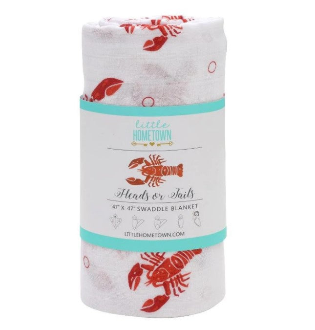Rolled white swaddle blanket with red lobster print and product label