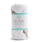 Rolled white muslin swaddle blanket with oyster print and Little Hometown brand packaging