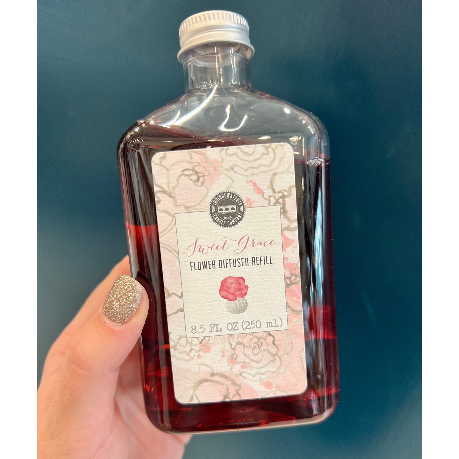 Sweet Grace flower diffuser refill bottle held in hand