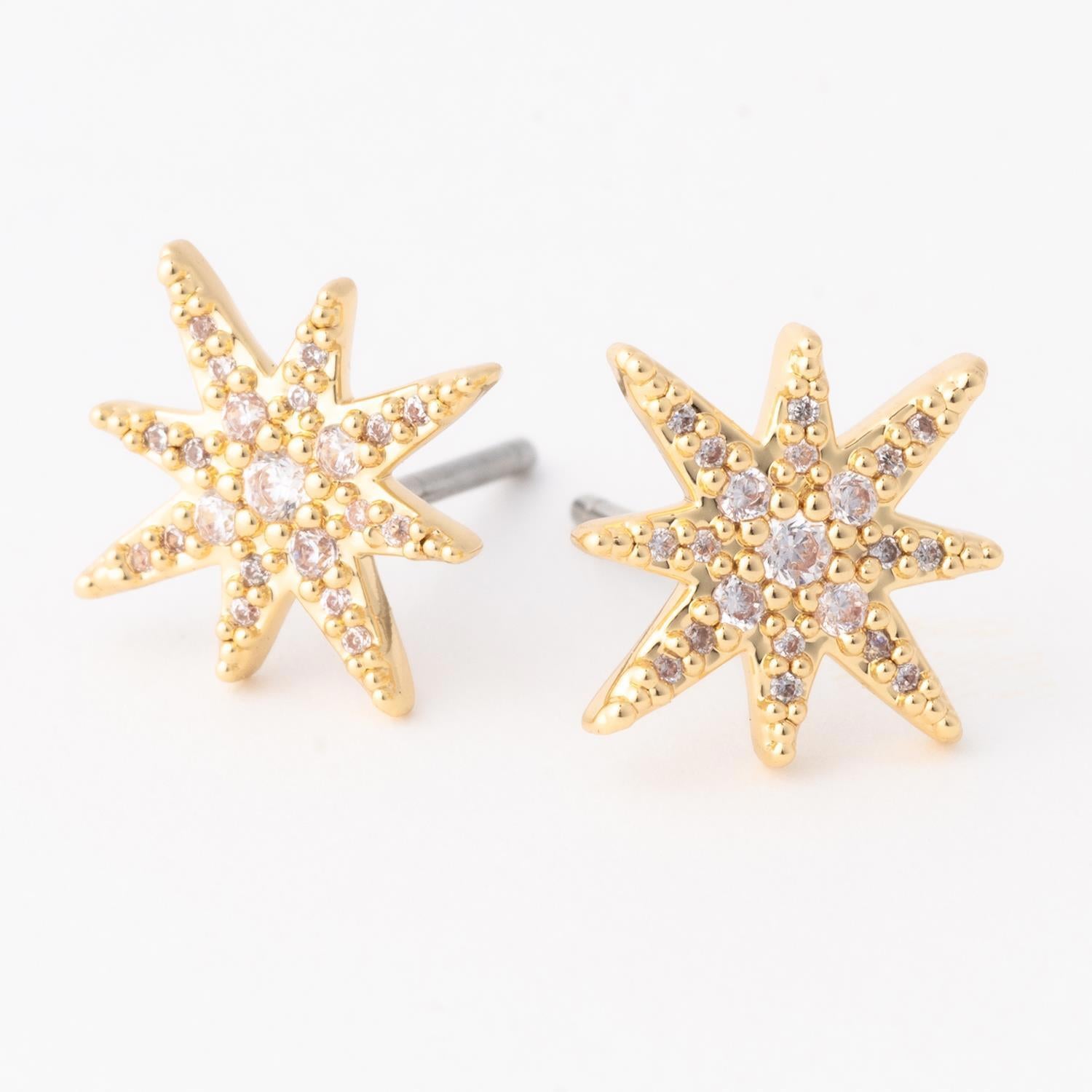 Gold star shaped stud earrings with embedded clear crystals
