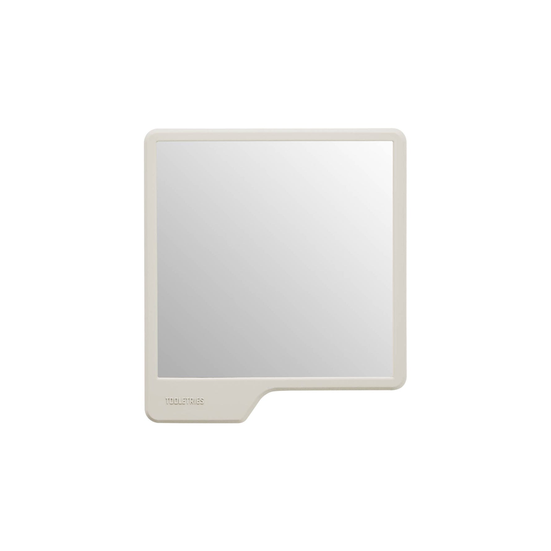 Tooletries square compact mirror with a light beige silicone frame and an embossed logo on the integrated bottom left tab