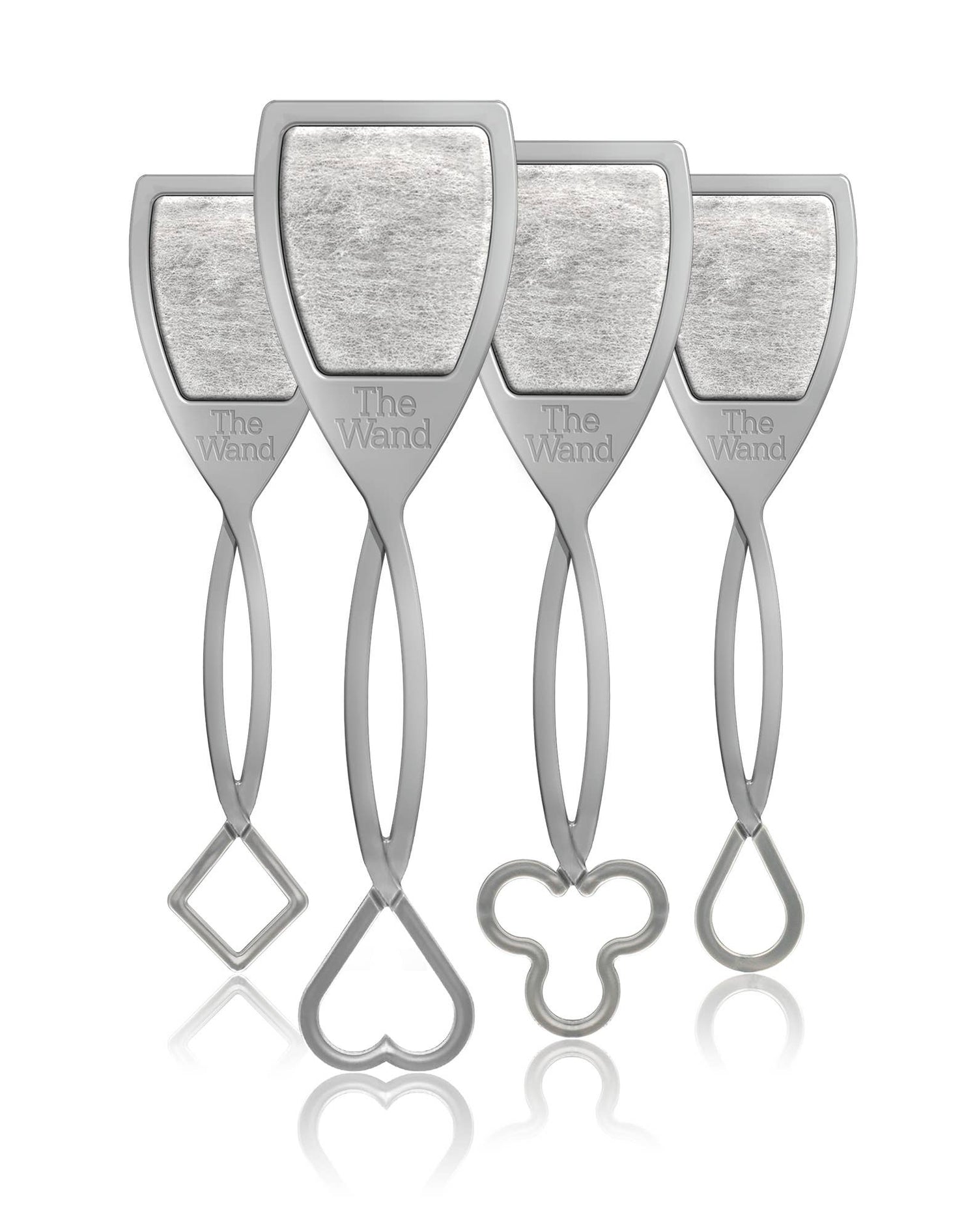 Product photography showing four identical grey The Wand wine purifiers each with a shield-shaped top containing a textured filter and distinct handle bottoms shaped as a square a heart a clover and a teardrop all reflected on a white surface