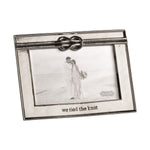 Mud Pie silver photo frame featuring a decorative knot design at the top and "we tied the knot" engraved at the bottom, holding a black and white wedding photo of a couple kissing on a sandy beach with the Mud Pie logo visible within the photo