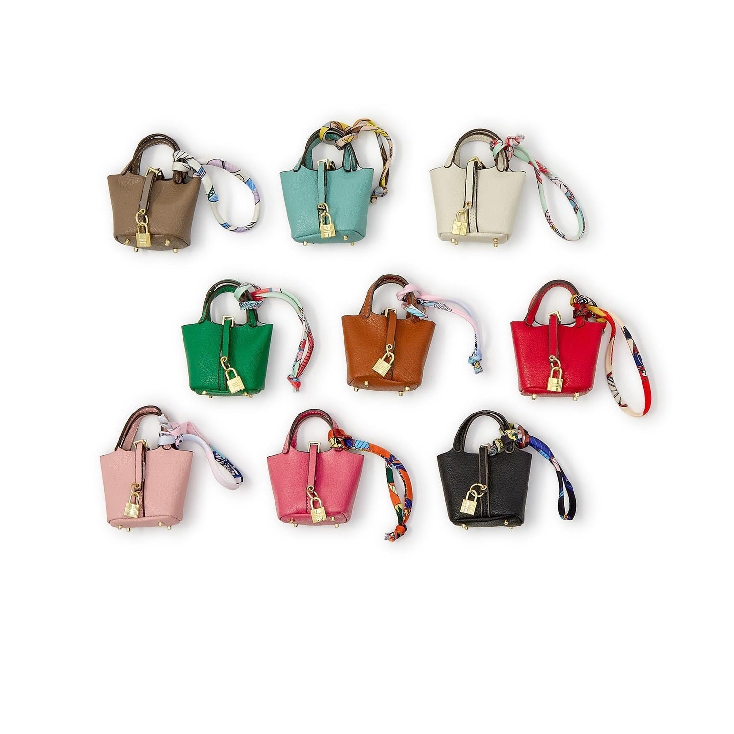 Collection of eight miniature bucket bags in various colors with gold padlocks and patterned silk ribbons
