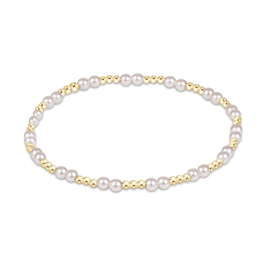 Stretch bracelet featuring alternating gold beads and white pearls