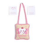 Textile tooth fairy pillow set featuring a beige pillow with pink trim and strap, embroidered with a smiling white tooth wearing a pink crown and wings, displayed with two white cards a pink moon and stars card for "This Tooth Belongs To" and a tooth fairy receipt card with smiling teeth