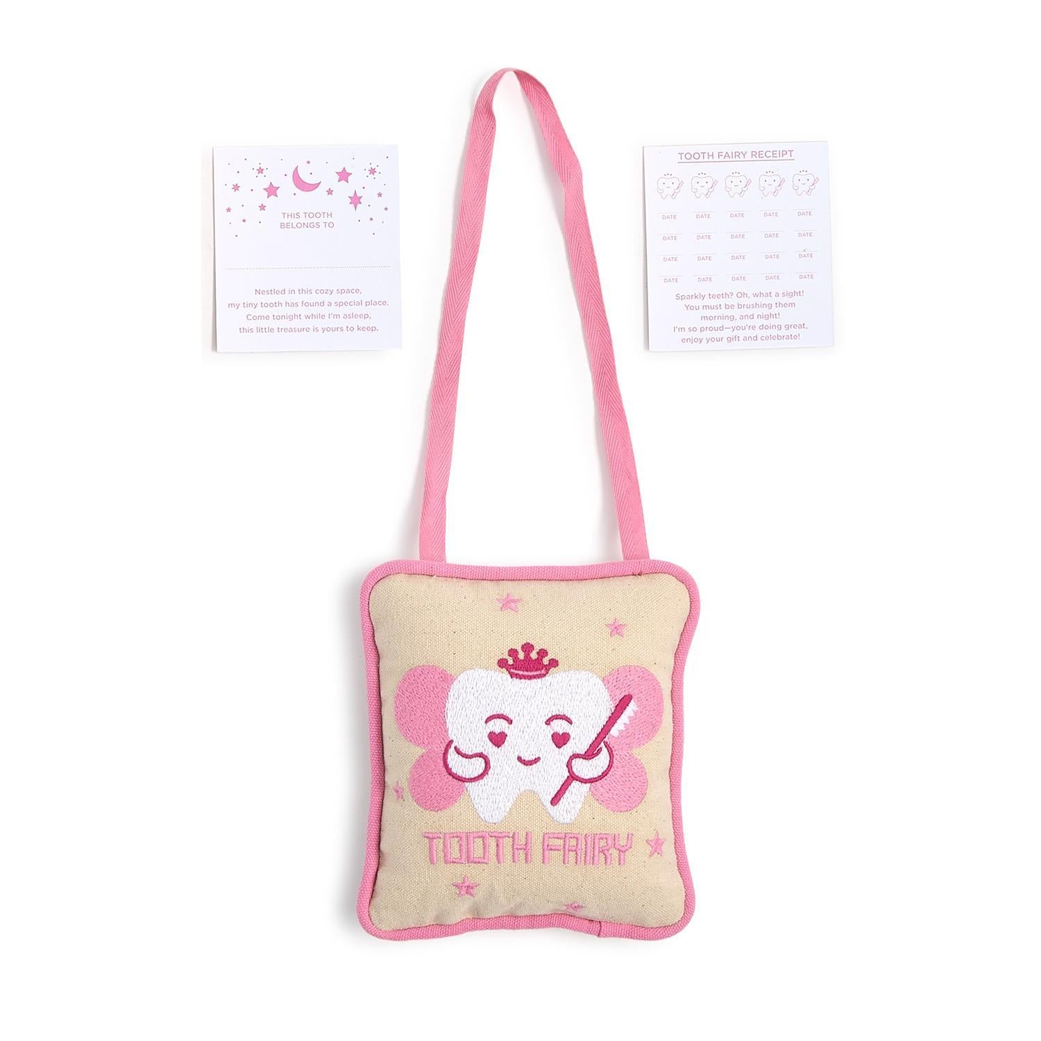 Textile tooth fairy pillow set featuring a beige pillow with pink trim and strap, embroidered with a smiling white tooth wearing a pink crown and wings, displayed with two white cards a pink moon and stars card for "This Tooth Belongs To" and a tooth fairy receipt card with smiling teeth