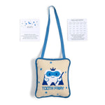 Product photo of a fabric Tooth Fairy pillow and two accompanying white cards against a white background, the cream-colored pillow features blue trim, a blue shoulder strap, an embroidered tooth character wearing a blue mask and crown holding a wand with blue stars and TOOTH FAIRY text, complemented by a THIS TOOTH BELONGS TO card with blue moon and stars and a TOOTH FAIRY RECEIPT card showing multiple tooth outlines and date fields