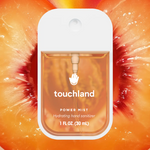 Touchland Power Mist hydrating hand sanitizer spray bottle against a peach background