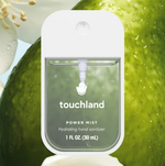 Touchland Power Mist hydrating hand sanitizer spray bottle against a lime background