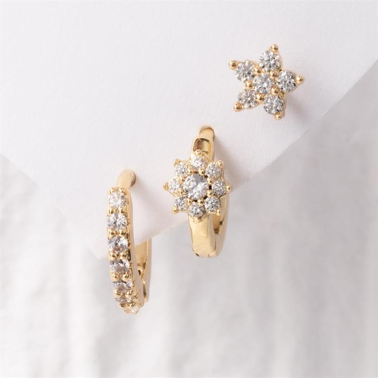 Gold-toned earring set showcasing a sparkling star stud, a floral cluster huggie, and a pavé hoop, all featuring clear diamond-like stones on a white background
