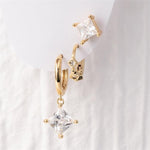 Gold earring set featuring a prominent square-cut clear stone dangle hoop, a smaller hoop with multiple tiny square gems, and a matching square stud earring for a layered look