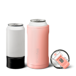 Brumate insulated drinkware featuring a white standard beverage can in a black koozie, a coral pink Brumate Hopsulator Duo with logo, and a clear lid with a pink sip-top closure