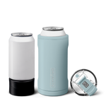Brumate product photography displays a white beverage can on a black coaster, a light blue Brumate insulated can cooler holding another beverage can with the brand logo embossed, and a clear flip-top lid with a matching light blue closure