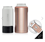 Brumate insulated can cooler in white with a black base next to a sparkling rose gold slim can holder featuring a rose gold ring and a separate clear MÜV Collection lid with a matching rose gold flip-top