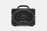Product photography of a dark grey Turtlebox Gen 2 portable speaker with a rugged design a prominent oval speaker grille a central circular tweeter a top carry handle and a white TURTLEBOX logo with an orange X on a plain white studio background
