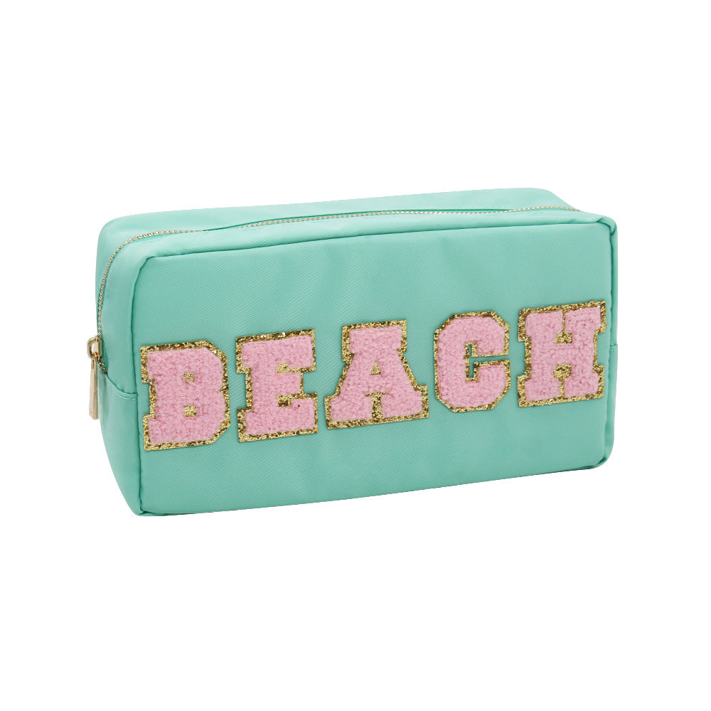Teal textile cosmetic pouch featuring the word BEACH in pink chenille letters outlined in gold glitter with a gold zipper