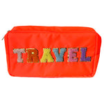 Photograph of a neon orange travel pouch with colorful fuzzy letters spelling TRAVEL, each letter outlined in gold glitter