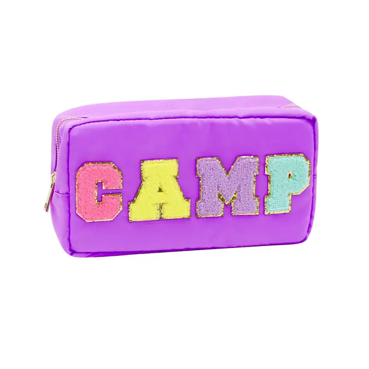 Rectangular purple fabric pouch featuring colorful fuzzy glitter letters spelling "CAMP" with pink C, yellow A, purple M, and teal P, and a visible zipper