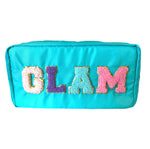 Teal cosmetic bag featuring the word GLAM spelled out in fluffy chenille patch letters with a gold glitter outline in pastel pink purple and light blue hues