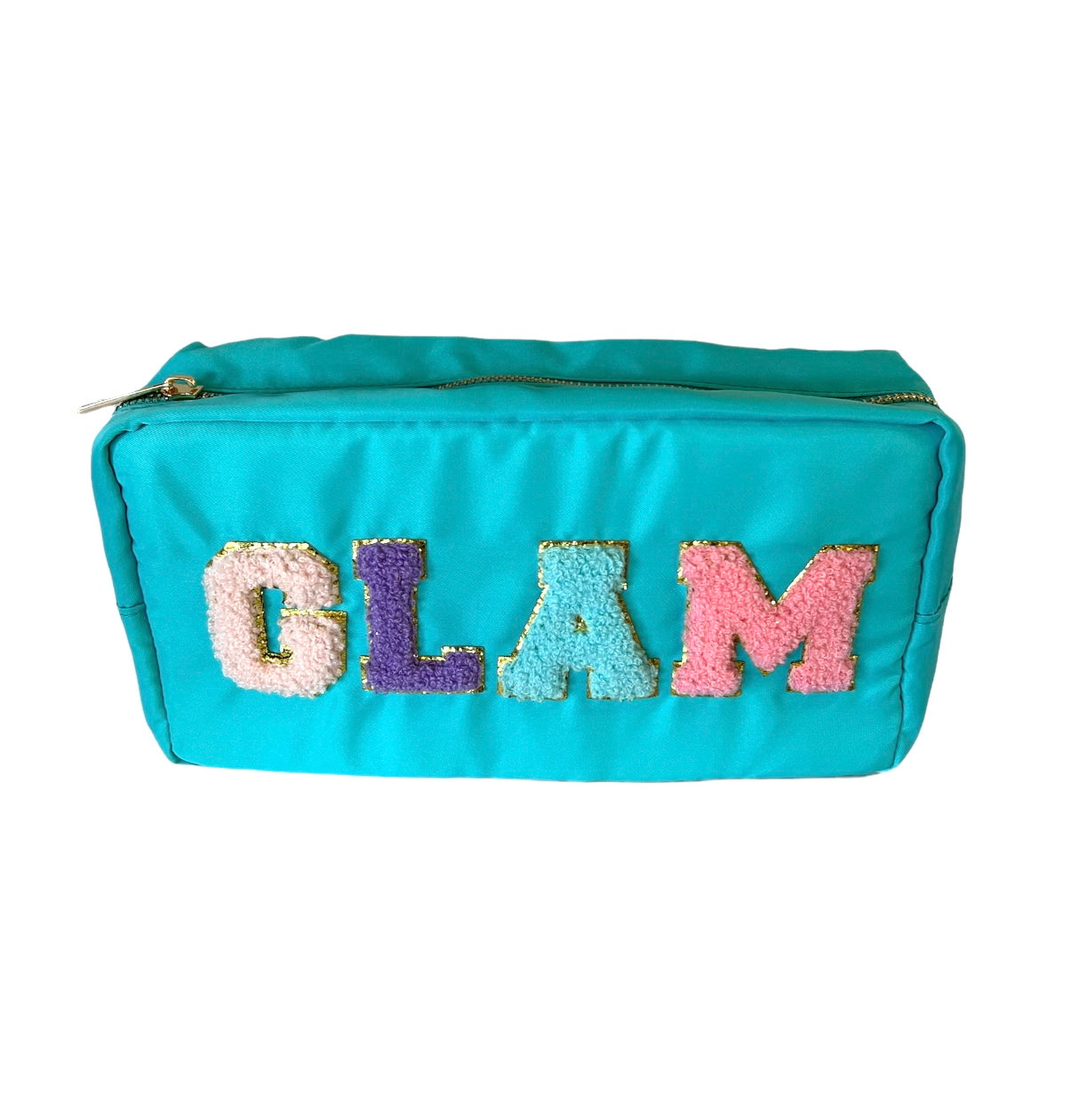 A turquoise cosmetic pouch featuring the word GLAM in fuzzy colorful patch letters with gold outlines and a gold zipper