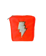 Neon orange zippered pouch displaying a fluffy white sherpa lightning bolt outlined in glittering gold
