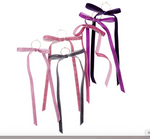 Five velvet ribbon bows with long tails and gold ring accents in shades of dusty rose dark pink charcoal gray vibrant purple and deep plum displayed on a white background