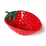 Ceramic strawberry bowl with a bright glossy red glaze, small raised bumps simulating seeds, and a green stem