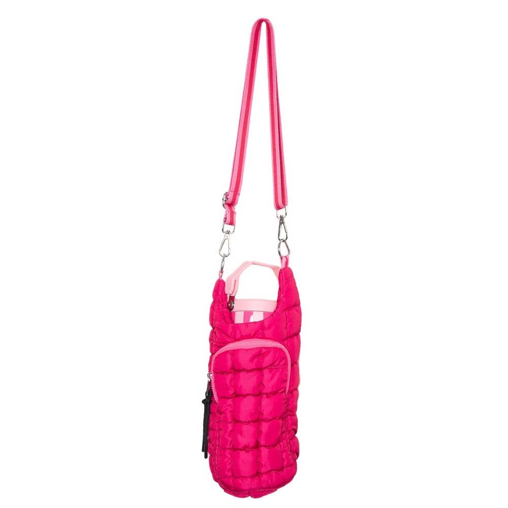 Photograph of a vibrant fuchsia pink quilted bottle holder bag with an adjustable striped shoulder strap and a small front zipper pocket presented against a white studio background