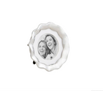 Silver metal photo frame with a wavy scalloped edge displaying a black and white photo of two women smiling brightly
