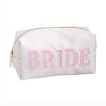 White satin cosmetic bag featuring BRIDE spelled in shimmering pink sequins with a gold zipper and tag