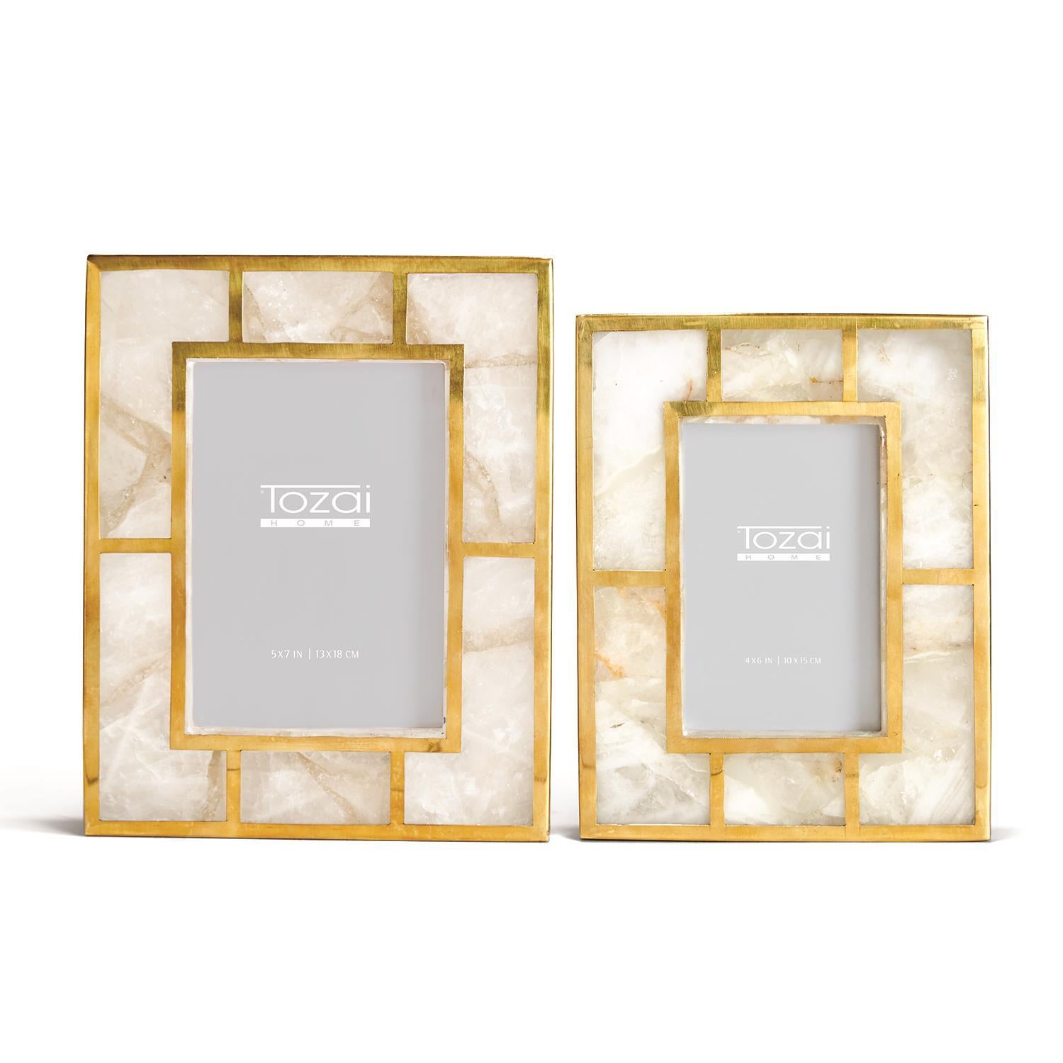 Two rectangular picture frames with gold metal borders and white stone inlay